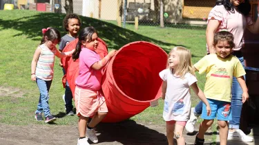 Children carrying a playground obstacle